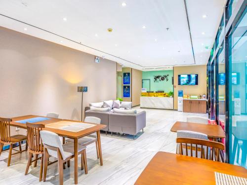 a living room with tables and a couch at 7Days Premium Beijing Zhongguancun Renmin University Suzhou Street Subway Station Branch in Beijing