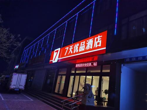 a store with a sign on the side of a building at 7Days Premium Qinhuangdao Lulong Bus Station Yongwang Avenue Branch in Qinhuangdao