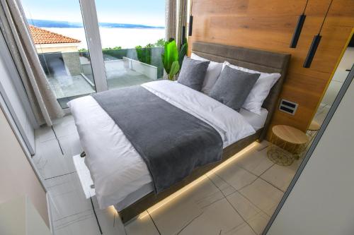 a bedroom with a bed with a view of the ocean at SPA House in Crikvenica
