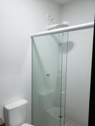a bathroom with a shower and a toilet at Flat Genoveva in Tangara da Serra