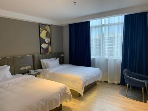 Ένα ή περισσότερα κρεβάτια σε δωμάτιο στο 7Days Premium Yunfu Yunan Branch