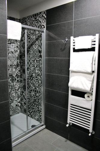 a bathroom with a shower with a glass door at Hotel Magenta in Florence