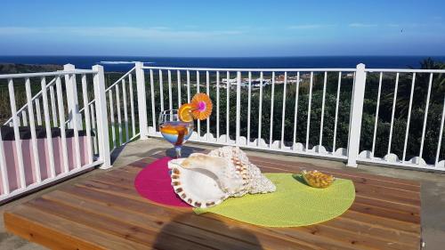 a table with a plate of food on a balcony at The Music House, Ilha Terceira, Açores in Praia da Vitória