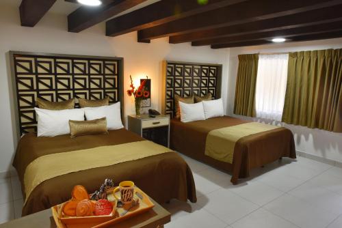 En eller flere senge i et værelse på Baja Inn Hoteles Rio
