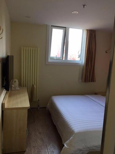 Ένα ή περισσότερα κρεβάτια σε δωμάτιο στο 7Days Inn South Beijing Railway Station Yangqiao