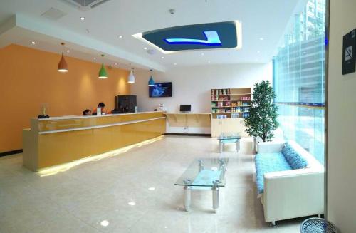 a lobby with a couch and a counter in a store at 7Days Inn Yibin Boxi City Center Branch in Yibin