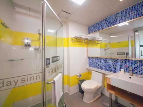 a bathroom with a shower and a toilet and a sink at 7Days Inn Shenzhen Guomao Metro Station in Shenzhen