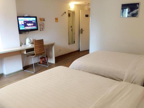 A bed or beds in a room at 7Days Inn Xiamen Jinshang branch
