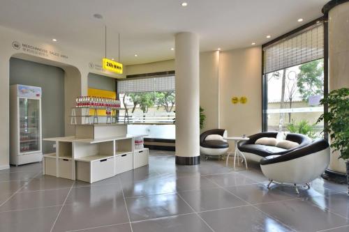 ein Wohnzimmer mit 2 Stühlen und einem Tisch in der Unterkunft 7Days Inn Dali Erhai Park Branch in Dali