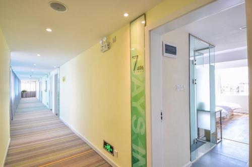 a hallway of a house with a glass door at 7Days Inn Dali Erhai Park Branch in Dali