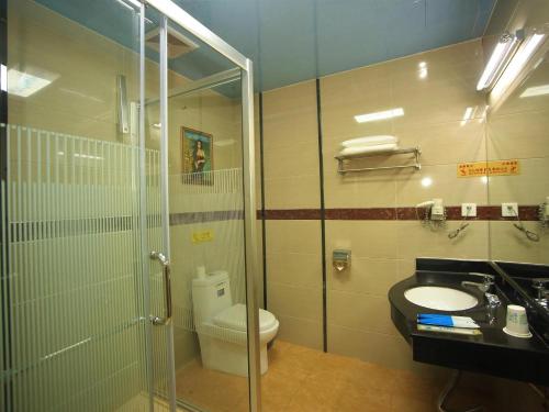 a bathroom with a shower and a toilet and a sink at 7Days Inn Foshan Pingzhou Jade Street East Gate Branch in Guangzhou