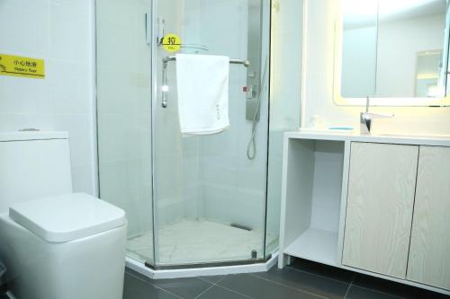 a bathroom with a shower and a toilet and a sink at 7Days Inn Neijiang Longchang Xinhua Street Branch in Neijiang
