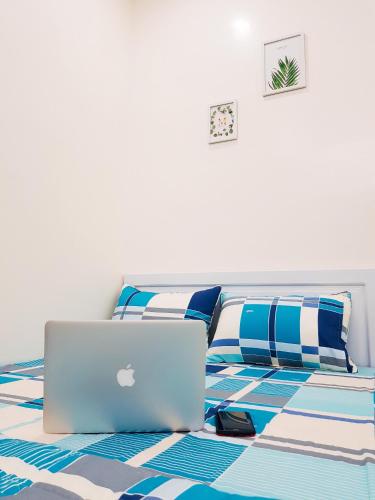 a laptop computer sitting on a bed in a bedroom at Quyen's house in Can Tho