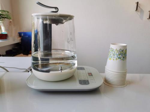 a blender sitting on a counter with a remote control at 7Days Inn Lu'an Wanda Plaza Branch in Lu'an