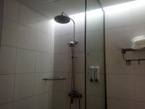 a bathroom with a shower with a glass door at 7Days Inn Xiaoyi People's Hospital Branch in Yaopu