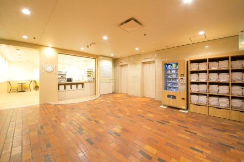 a large room with a hardwood floor in a store at Hotel S-Plus Hiroshima Peace Park in Hiroshima