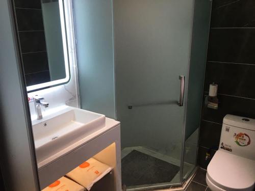 a bathroom with a sink and a shower and a toilet at 7Days Inn Hengshui Hengbai International Branch in Hengshui