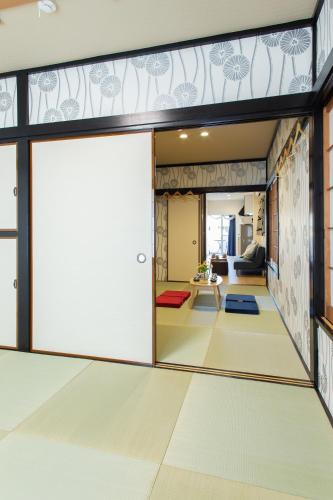 an open door in a room with a living room at My Home in Tokyo in Tokyo
