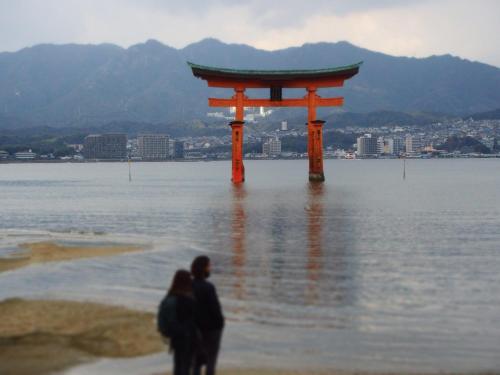 a torii gate in the middle of a body of water at Hotel S-Plus Hiroshima Peace Park in Hiroshima