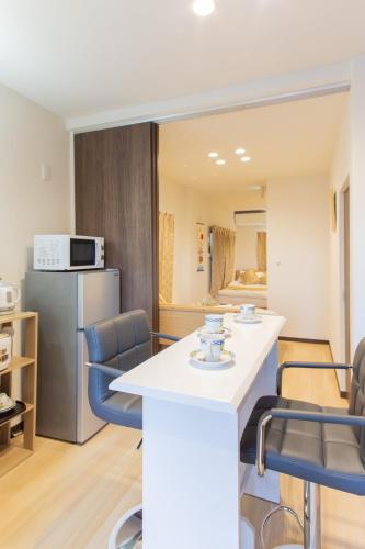 a kitchen and dining room with a counter and chairs at My Home in Tokyo in Tokyo