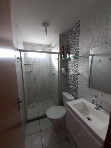 a bathroom with a toilet and a shower and a sink at Residencial Maravilha - Poço in Maceió