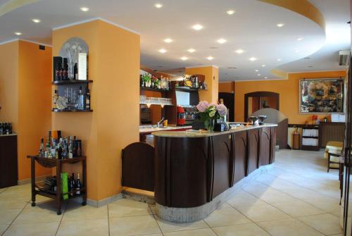 a bar in a restaurant with flowers on the counter at Hotel Cigno Reale in Rolo