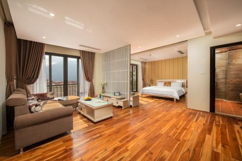 a living room with a bed and a couch at Sapa Green Hotel in Sa Pa