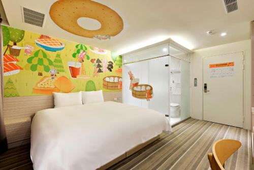 a bedroom with a white bed and a donut wall at Whoops Hotel in Taichung