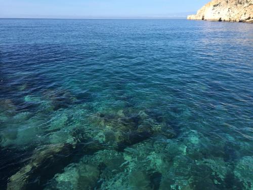 a large body of water with rocks and reefs at Beso Patara in Patara