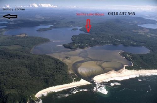 an aerial view of a lake with a red marker at Smiths Lake House in Smiths Lake