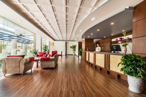 an office lobby with a reception desk and chairs at The Sunriver Boutique Hotel Hue in Hue