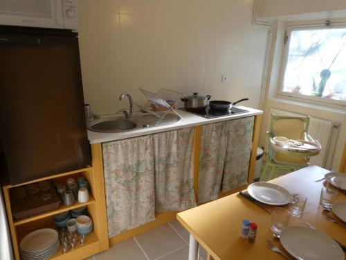 a kitchen with a sink and a counter top at Les chambres du Ladoux in Puy-de-Fourches