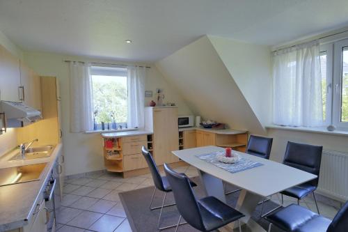 a kitchen with a table and chairs in a room at Landhaus Dreesen in Timmendorfer Strand