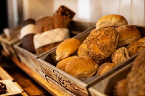 a bunch of different types of bread in trays at Lisebergsbyns B&B in Gothenburg