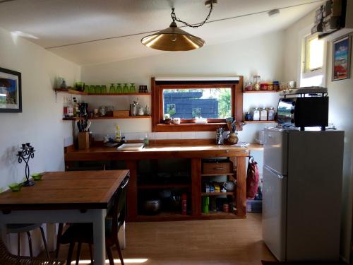 a kitchen with a table and a refrigerator at Southern Scenic Stargazer in Riverton