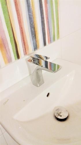a bathroom sink with a chrome water faucet at Sonce in Izola