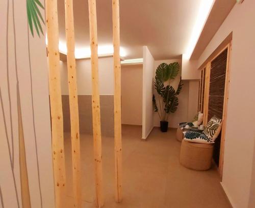 a hallway with a wooden door in a room at Alexakis Hotel & Spa in Loutra Ipatis