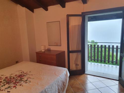 a bedroom with a bed and a sliding glass door at Mamma Teresa in Sestola