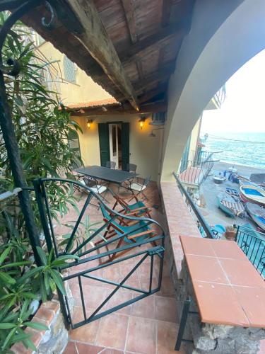 a balcony with a table and chairs and the ocean at La casa al mare in Nerano