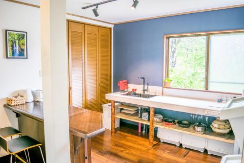 a kitchen with a sink and a window at Myoko House in Myoko