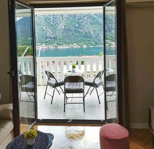 a room with a table and chairs on a balcony at Ana's Place in Kotor