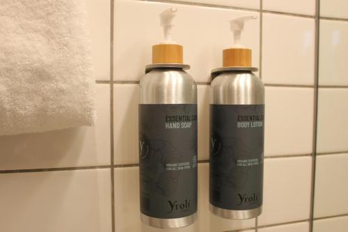 a couple of bottles on a wall in a bathroom at Skovshoved Hotel in Charlottenlund