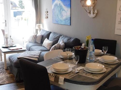 a living room with a table and a couch at Ferienhaus-Steinburg in Steinburg