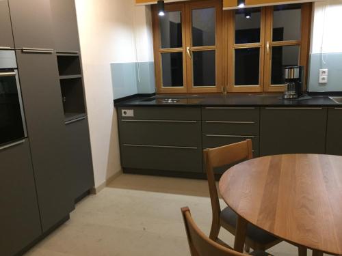 a kitchen with a wooden table and a dining room at LICHTECK - Helle Ferien in Breitenberg
