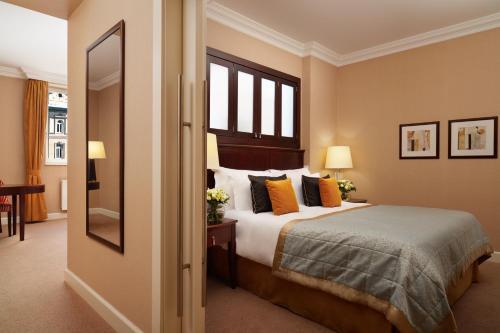 a hotel room with a bed and a window at Corinthia Budapest in Budapest