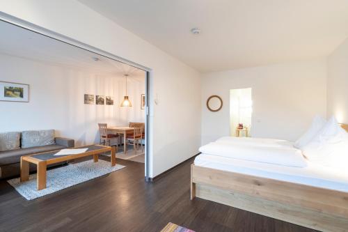 a bedroom with a bed and a living room at Ferienwohnung Schmid in Oberstdorf