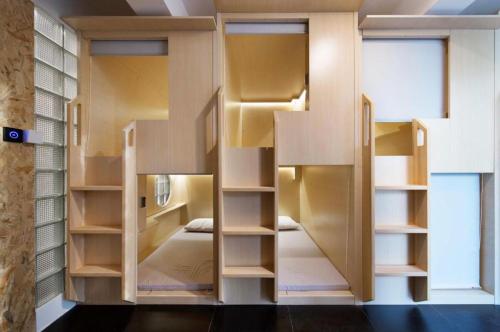 a room with two bunk beds and a window at WeFlow Hostel (Shanghai Hongkou) in Shanghai