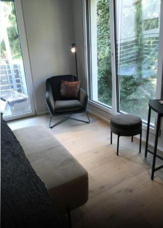 a living room with a chair and a chair at Hotel Garni Villa Rosengarten in Überlingen