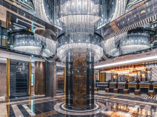 a large lobby with chandeliers in a casino at APA Hotel Shin-Osaka Ekimae in Osaka