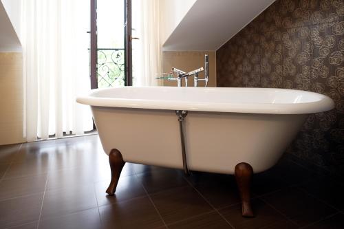 a white bath tub in a bathroom with a window at Wilhelminenhof in Trausdorf an der Wulka